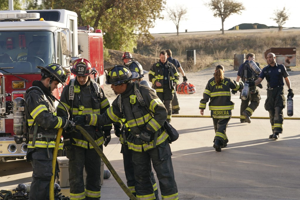 Ben Warren (Jason George) et Theo Ruiz (Carlos Miranda) vérifient un tuyau avec un autre pompier